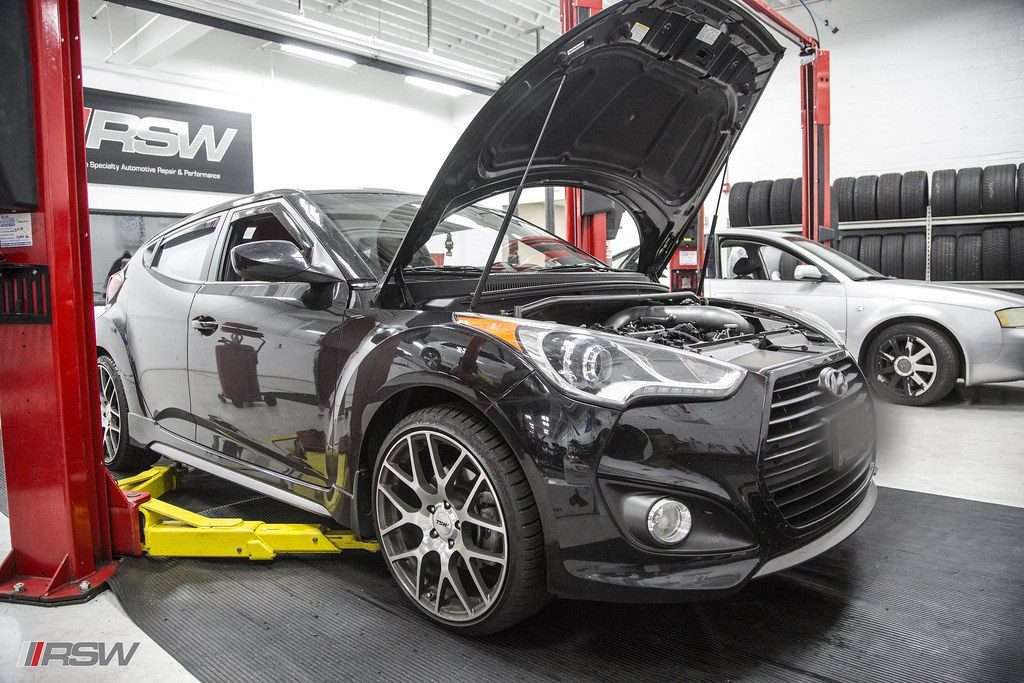 A Hyundai Veloster on the lift with the hood open at RSW Auto Repair in Kinnelon, NJ