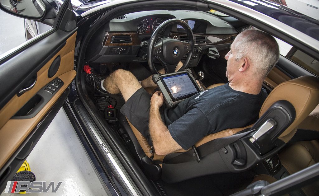 A technician reading module data from inside the car at RSW Auto Repair in Kinnelon, NJ